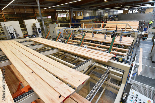 woodworking/ sawmill: production and processing of wooden boards in a modern industrial factory - assembly line in production