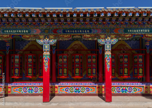 Beautifully painted and adorned prayer wheels in Wutun si monastery, Qinghai province, Wutun, China photo