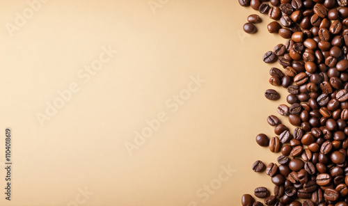 Close-up of a collection of roasted coffee beans bringing out a rich color, are arranged in a semicircular pattern on the right side leaving copy space on the plain light colored background.