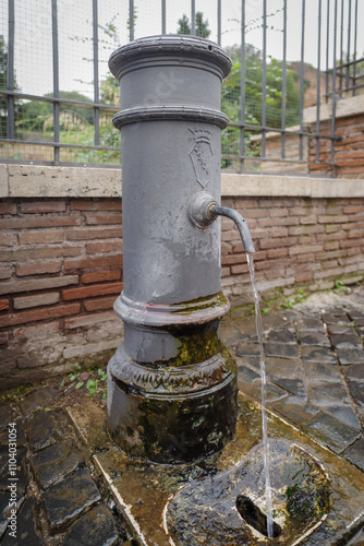 Old street public drinking fountain in Rome photo