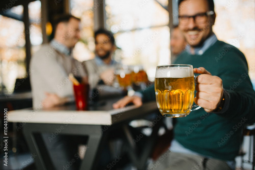 Man holding beer glass in pub Man holding beer glass in pub