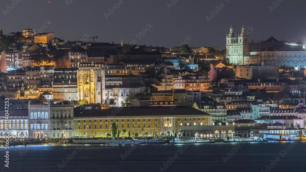 Aerial timelapse of Lisbon's illuminated historic center, Terreiro do Paco and Tagus River at twilight, featuring historic buildings, ferry terminal and Se de Lisboa Cathedral, Portugal Aerial timelapse of Lisbon's illuminated historic center, Terreiro do Paco and Tagus River at twilight, featuring historic buildings, ferry terminal and Se de Lisboa Cathedral, Portugal