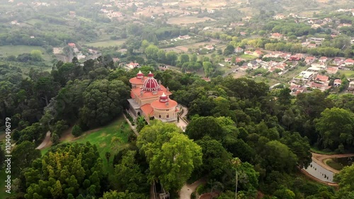 Aerial footage of Monserrate Palace in Sintra Portugal surrounded by dense greenery captured from a drone showcasing majestic architecture and lush forest landscape photo