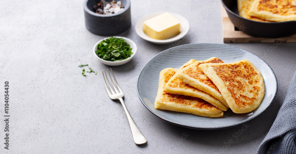 Traditional Scottish tattie potato scones on a plate. Grey background. Copy space. Traditional Scottish tattie potato scones on a plate. Grey background. Copy space.