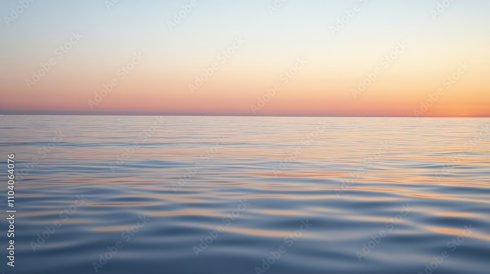 Fototapeta premium A serene view of calm ocean waters at sunset, showcasing soft waves and a gradient sky.