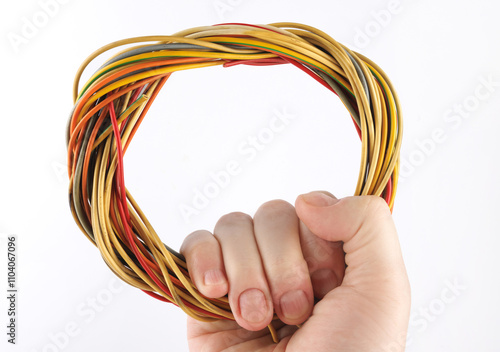 Close-up of multi-core cables woven into a circle on a white background. photo