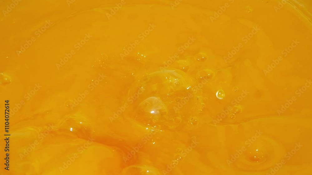 Lemon slices splashing into bright orange juice, creating vibrant waves in slow motion 300fps Lemon slices splashing into bright orange juice, creating vibrant waves in slow motion 300fps