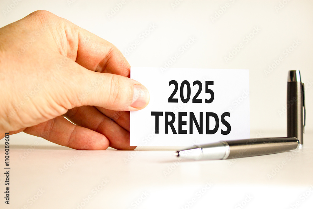 Planning 2025 trends new year symbol. Concept words 2025 Trends on beautiful white card. Beautiful white background. Businessman hand. Business 2025 trends new year concept. Copy space. Planning 2025 trends new year symbol. Concept words 2025 Trends on beautiful white card. Beautiful white background. Businessman hand. Business 2025 trends new year concept. Copy space.