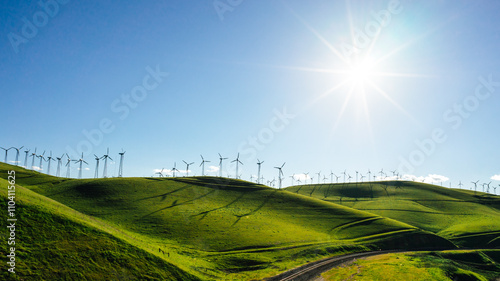 Sunburst over Rows of Wind turbines on top of rolling hills, Altamont Pass, California, USA photo