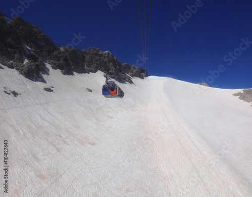 marmolada glacier over 3000 meters altitude with cable car transporting  people photo