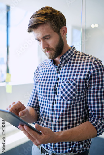 Serious, business and man at office with tablet on internet for research, reviews or post as social media manager. Male person, employee and texting on website or online for email or communication