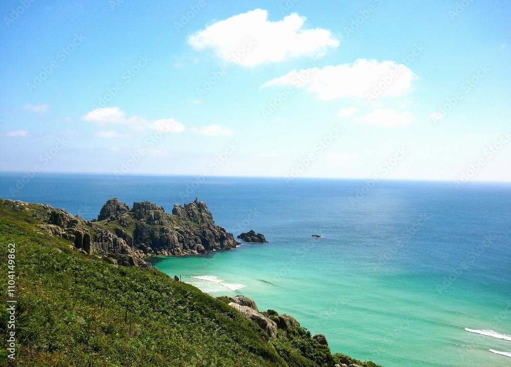 Fototapeta premium Picturesque headland overlooking open ocean with small private beach in Cornwall, England