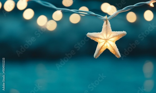 Christmas star string lights on blue night background with defocused bokeh; blue, white, gold colors 