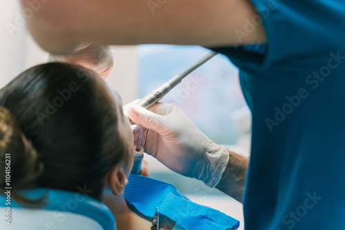 Dentist Performing Dental Procedure on Patient in Clinic photo