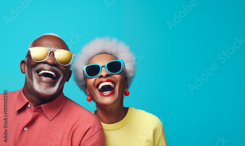 	
Smiling black senior couple whith glasses, isolated blue color background, image with space for text	
