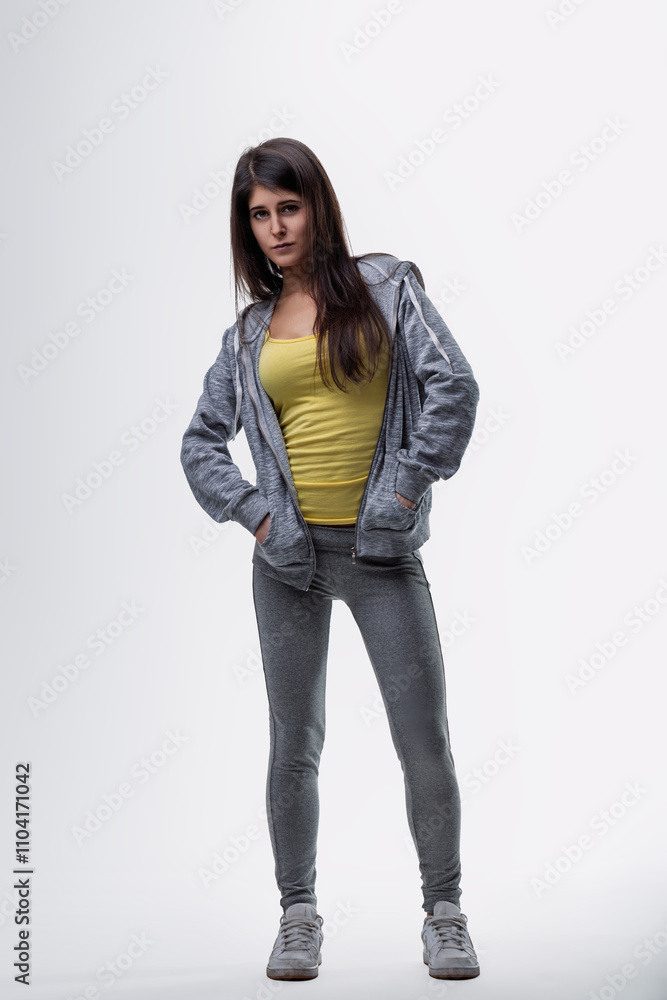 Young woman posing with hands in pockets, looking at camera Young woman posing with hands in pockets, looking at camera