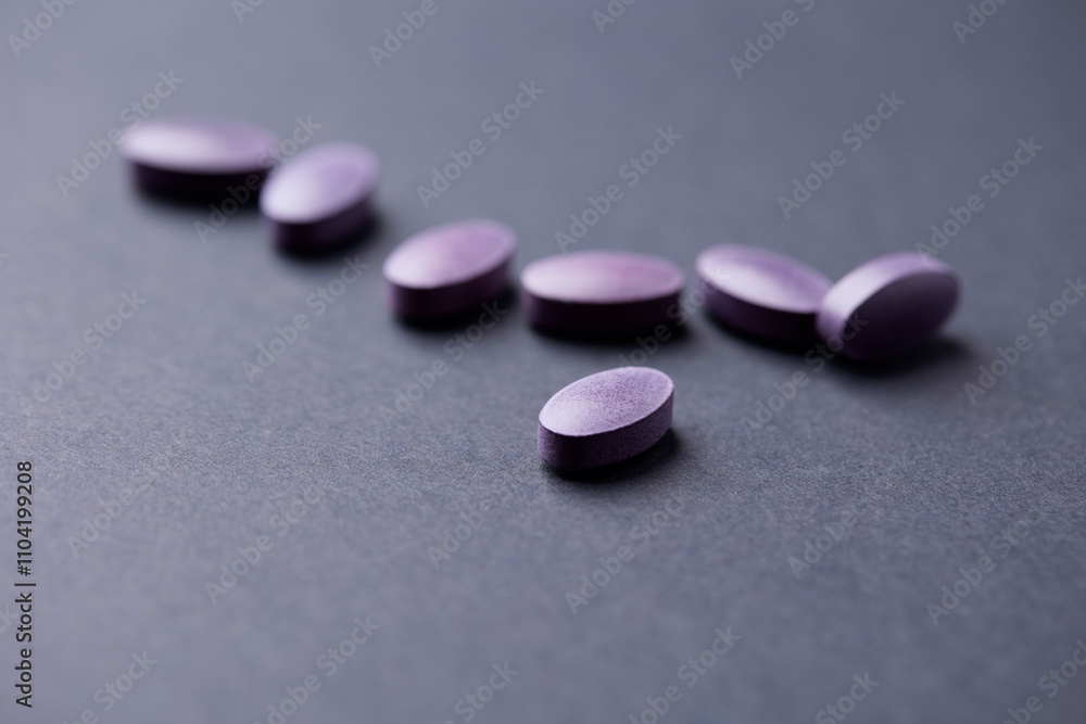 Lutein tablets. Dietary supplement on paper background. Soft focus. Close up. Copy space Lutein tablets. Dietary supplement on paper background. Soft focus. Close up. Copy space