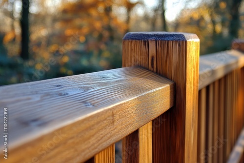 Detailed Close-up of Weathered Wood Deck Rail with Autumn Foliage Backdrop