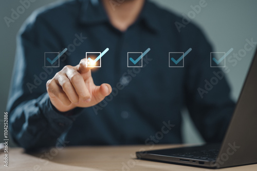 check, document, checklist, choice, guarantee, answer, assurance, certificate, choose, list. A person is using a laptop and has a check mark on it. They are pointing at the check mark.