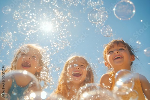 Happy children enjoying bubbles on a sunny day under a clear blue sky