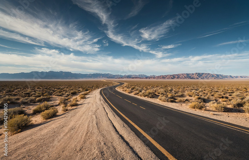 winding road in a vast desert landscape, with an empty sky above