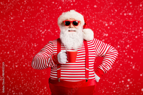 Portrait of his he nice attractive handsome cheerful cheery Santa drinking cacao latte holly jolly festal good mood isolated on bright vivid shine vibrant red color background