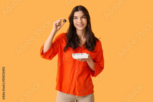 Happy young woman with box ...