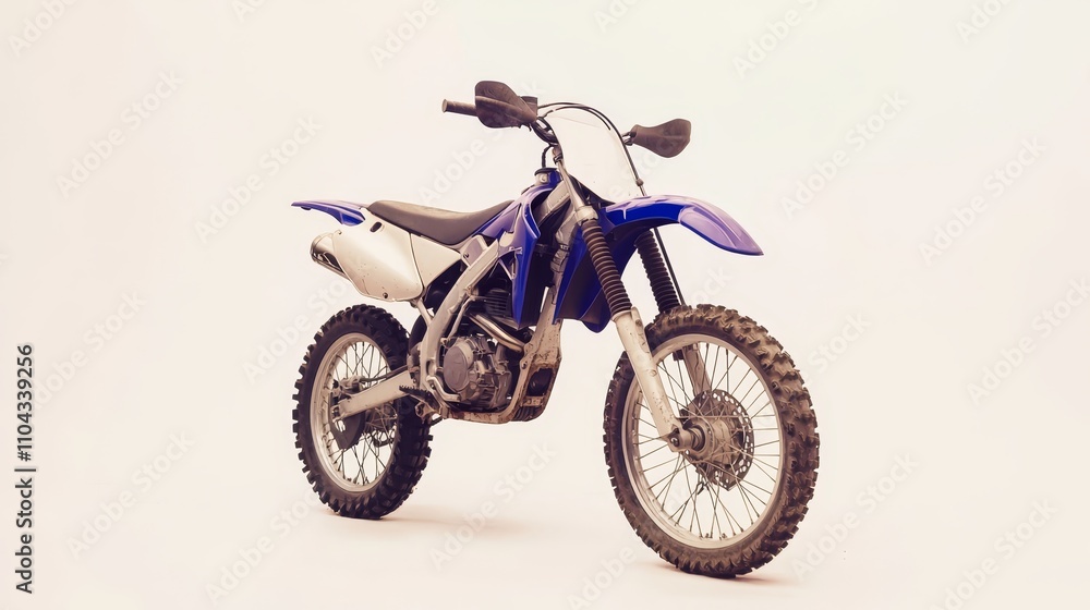 a blue and white dirt bike sitting on top of a white surface The bike has a blue body with white accents, and the background is a bright white a blue and white dirt bike sitting on top of a white surface The bike has a blue body with white accents, and the background is a bright white