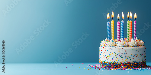 Birthday cake with festive candles on a blue background with space for text