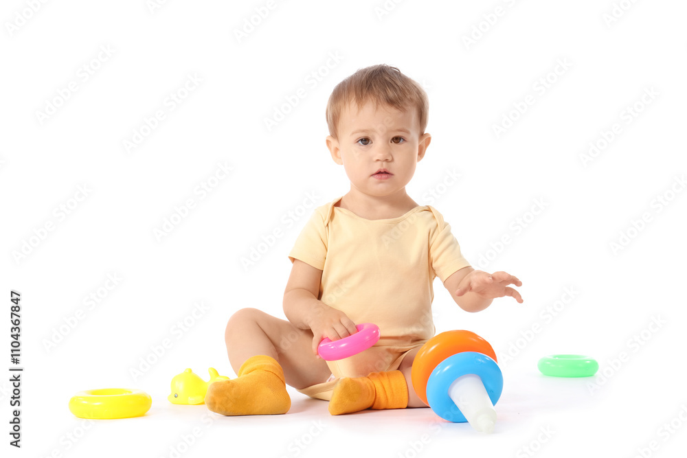 Cute baby girl in bodysuit playing with toy pyramid on white background Cute baby girl in bodysuit playing with toy pyramid on white background