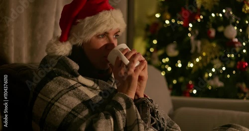 Woman Relaxing by Christmas Tree with Mug