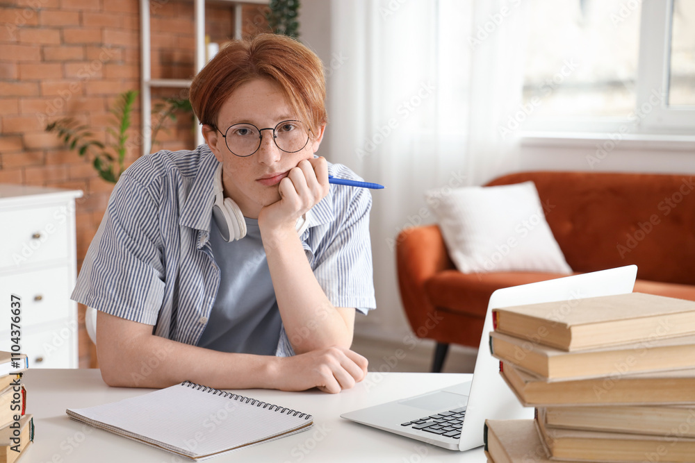 Tired male student in eyeglasses studying at home Tired male student in eyeglasses studying at home