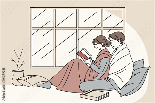 Couple reading together in winter window nook