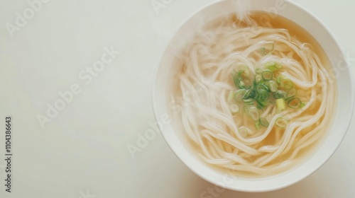 家庭料理をテーマにした、きれいな白い背景に湯気の立つ麺スープを空から撮影した画像 photo