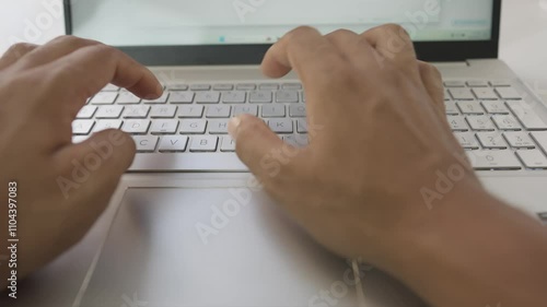 Closeup slim laptop keyboard typing by hand on white table background