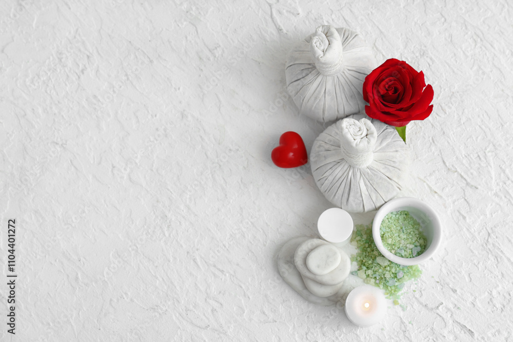Spa composition with herbal massage bags and rose flower on light background. Valentine's Day celebration Spa composition with herbal massage bags and rose flower on light background. Valentine's Day celebration
