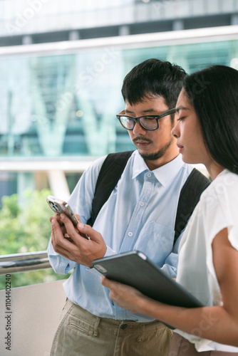 young asian business people talking, in Background builidings in Bangkok, Thailand photo