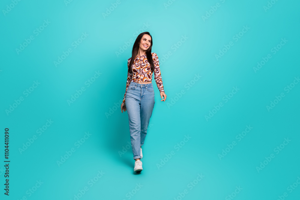 Full length photo of cheerful pretty lady dressed retro shirt walking looking empty space isolated blue color background Full length photo of cheerful pretty lady dressed retro shirt walking looking empty space isolated blue color background