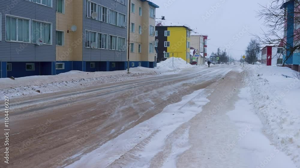 This is the north, fellow drivers. An ice-covered road (icy condition of roads), drifting snow in polar city. The road is covered with sand. Severe weather events, poor driving superhighway conditions This is the north, fellow drivers. An ice-covered road (icy condition of roads), drifting snow in polar city. The road is covered with sand. Severe weather events, poor driving superhighway conditions