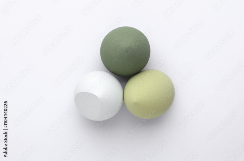 Set of Eggs makeup sponges. Blenders for foundation on gray background. Top view. Beauty concept Set of Eggs makeup sponges. Blenders for foundation on gray background. Top view. Beauty concept