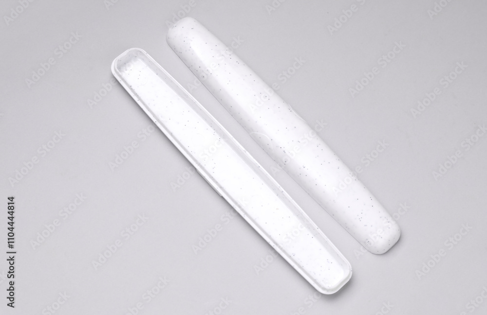 Mockup of white toothbrush storage case on grey background Mockup of white toothbrush storage case on grey background