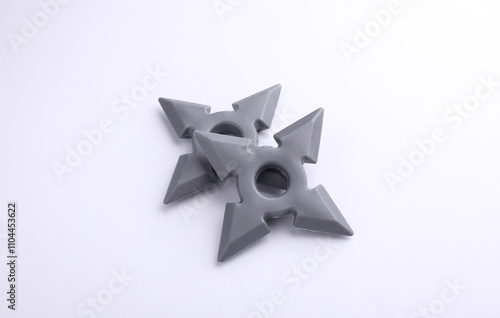 Toy plastic ninja shurikens on white background photo