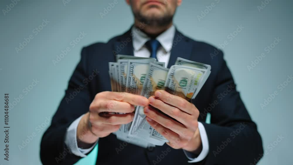 Formally dressed man is counting US Dollar bills, close-up. Formally dressed man is counting US Dollar bills, close-up.