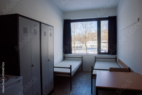 Small bedroom in a Dutch asylum seekers center showcases simple living conditions