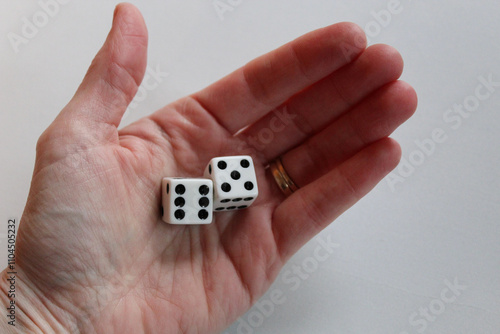 palm of hand with two dice of six and five isolated on white background. sixty-five 65 entertainment or retirement theme backdrop photo