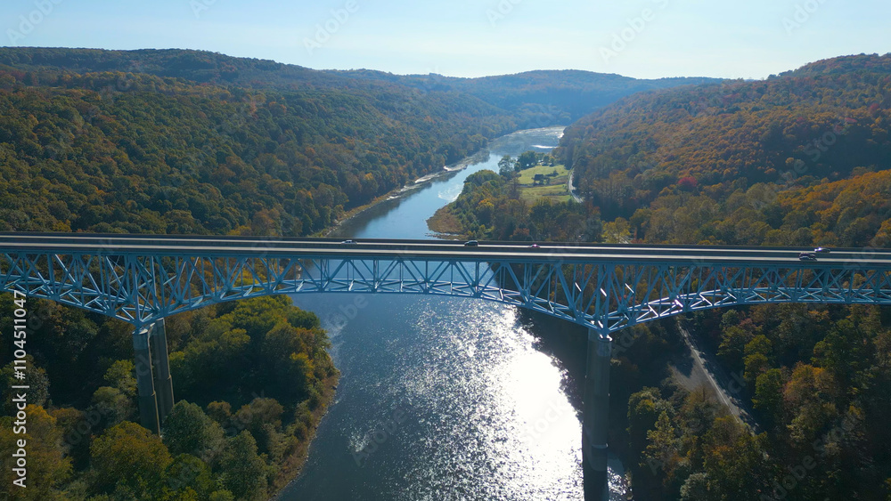 Aerial view of a highway bridge spanning across a river valley with beautiful Fall foliage Aerial view of a highway bridge spanning across a river valley with beautiful Fall foliage