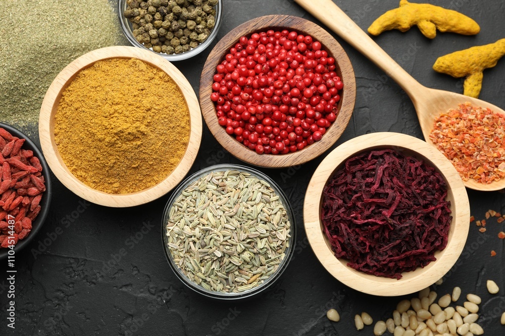 Different aromatic spices on black table, flat lay Different aromatic spices on black table, flat lay