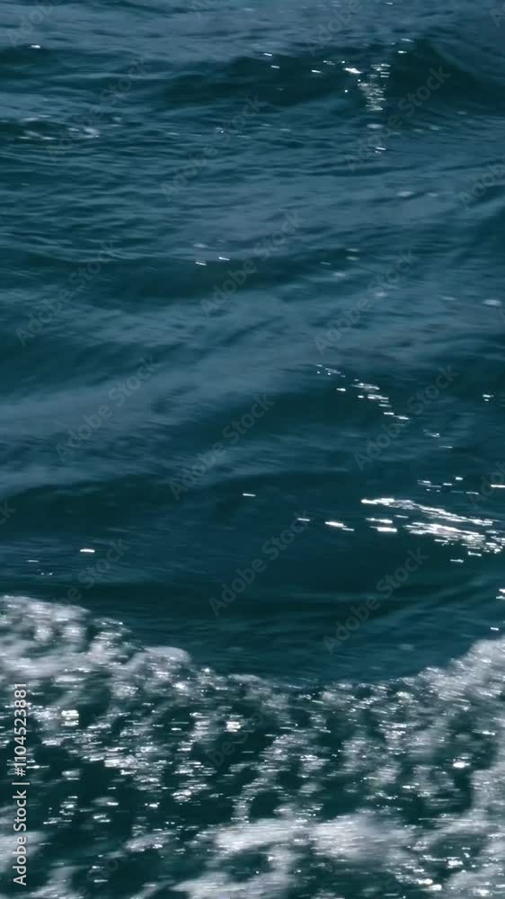 waves from the ship wake of water seen from behind of fast-moving speed boat on the sea with island in background in a clear sky day, blue sea, water surface waves from the ship wake of water seen from behind of fast-moving speed boat on the sea with island in background in a clear sky day, blue sea, water surface