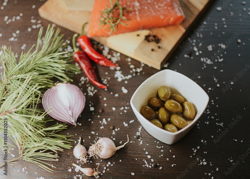 Fresh red salmon on a wooden tray with pepper, salt, garlic, red onion, red pepper, olives with jam Fresh red salmon on a wooden tray with pepper, salt, garlic, red onion, red pepper, olives with jam