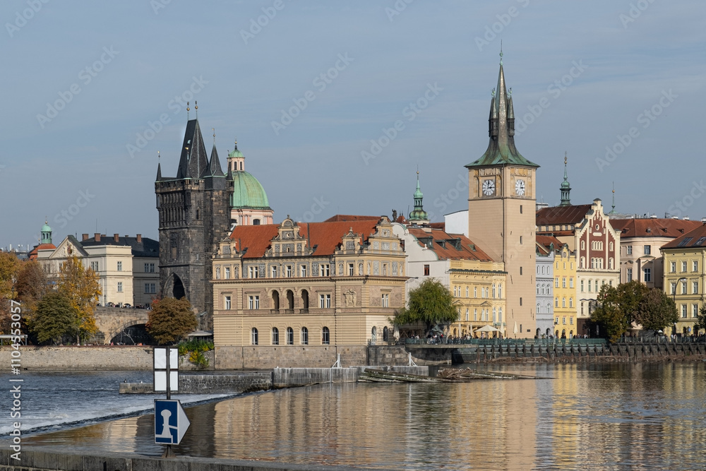 Autumn cityscape of Prague with a view of the Old Town. Gothic-style historic buildings are reflected in the Vltava River's calm waters. Autumn cityscape of Prague with a view of the Old Town. Gothic-style historic buildings are reflected in the Vltava River's calm waters.